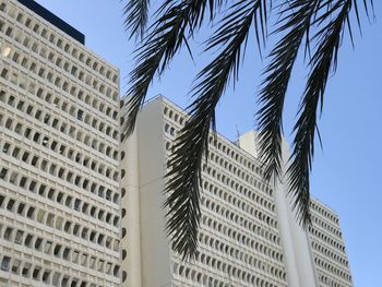 Low angle view of tall buildings against sky
