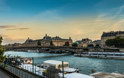 View of river in town at sunset