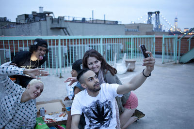 Friends hanging out on a building rooftop