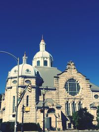 Low angle view of church against blue sky