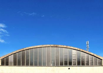 Low angle view of bridge against blue sky