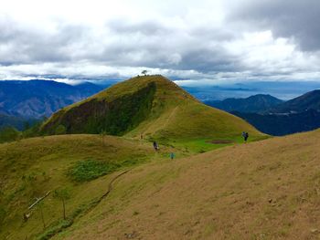 Scenic view of mountains against cloudy sky