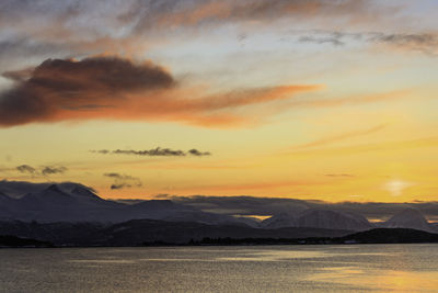 Scenic view of lake against orange sky