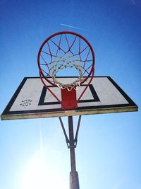 Low angle view of ferris wheel against clear blue sky