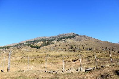 Scenic view of mountains against clear blue sky