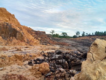 Rock formations on landscape against sky