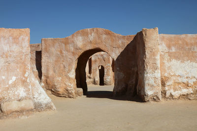 Exterior of old ruins against clear blue sky