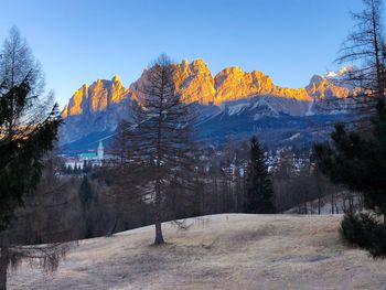Scenic view of snow covered landscape and mountains against sky