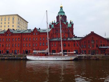 Boats in canal with buildings in background