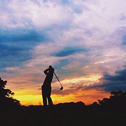 Silhouette of man standing at sunset