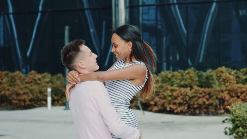 Happy couple embracing outdoors