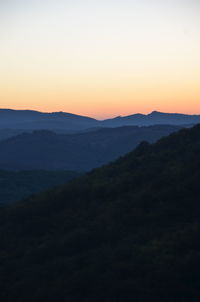 Scenic view of silhouette landscape against sky during sunset