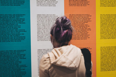 Rear view of woman with text