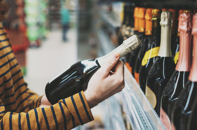 Man chooses wine at supermarket