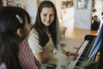 Sisters bonding over playing piano together