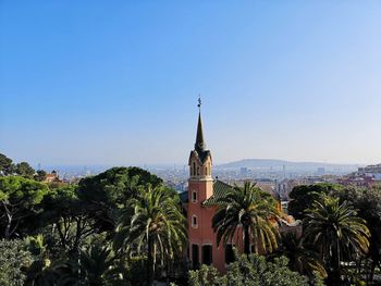 Palm trees and buildings against sky