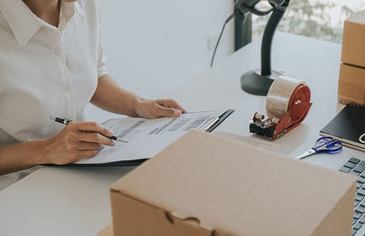 Midsection of woman working on table