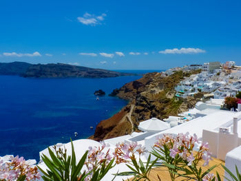 High angle view of swimming pool by sea against blue sky