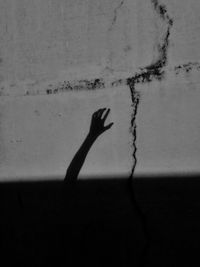 Shadow of person hand on wall