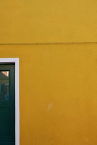 Close-up of yellow wall of building