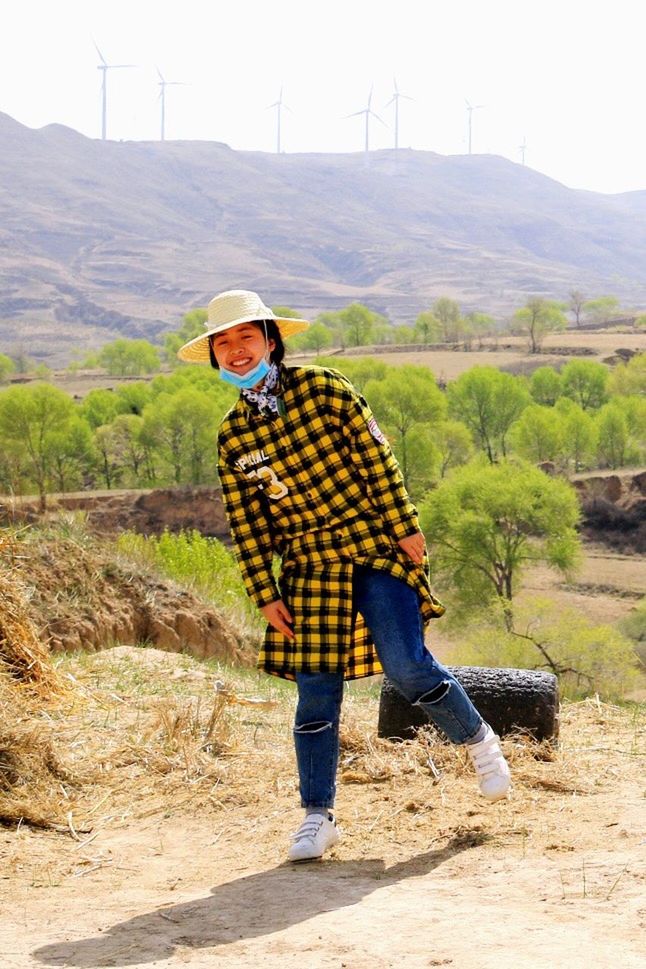 full length, lifestyles, leisure activity, rear view, casual clothing, landscape, men, mountain, field, sky, standing, rural scene, nature, person, clear sky, day, outdoors, sunlight