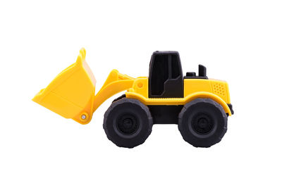 Close-up of yellow toy car against white background