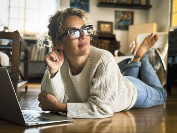 Young woman using laptop while sitting at home