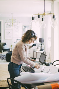 Woman setting up workplace at home