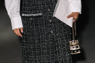 Midsection of man standing against wall