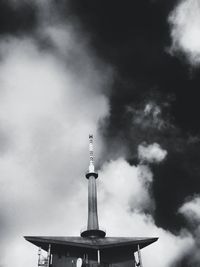 Low angle view of tower against cloudy sky