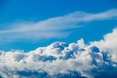 White fluffy cumulus clouds against a clear blue sky. a symbol of dreams and freedom. 