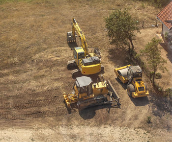 Yellow tractors and excavators top view