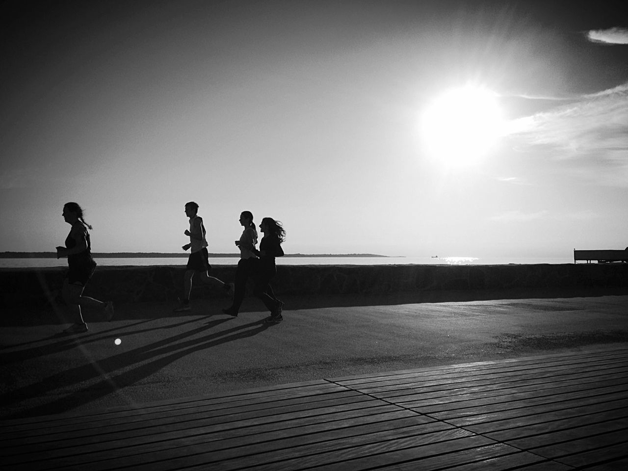 sun, sunlight, full length, lifestyles, leisure activity, sunbeam, walking, men, clear sky, railing, sunny, lens flare, water, sky, person, rear view, standing, togetherness