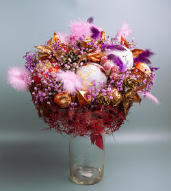 Close-up of pink flower vase against white background