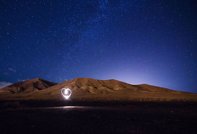 Scenic view of desert against sky at night