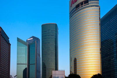 Low angle view of buildings against blue sky