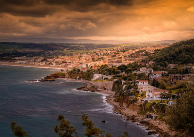 High angle view of chenoua village by sea against sky