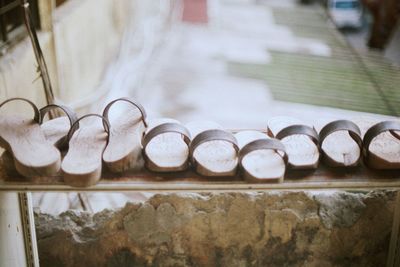 High angle view of wooden slippers on railing