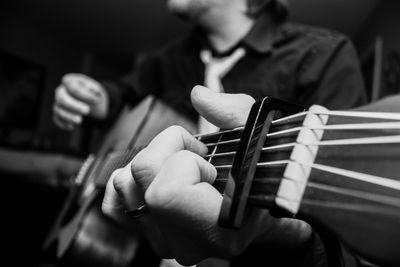 Close-up of man playing guitar