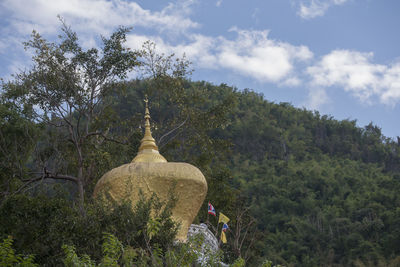 People in temple against sky