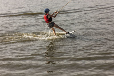 Man kite boarding in river