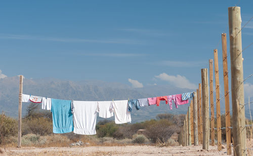 Clothes drying on clothesline against sky