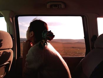 Young woman sitting in car