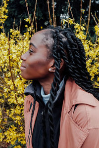 Portrait of woman standing against plants