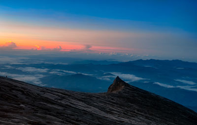 Scenic view of mountain against cloudy sky