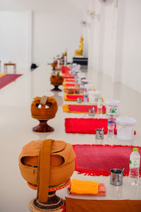 Close-up of alms bowls on table at temple