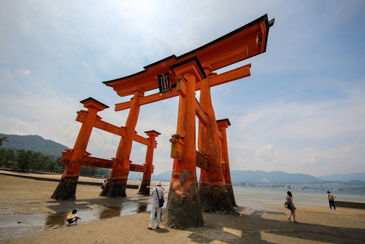 famous place, tourism, mountain, sky, built structure, travel destinations, leisure activity, architecture, torii gate, tourist, mountain range, outdoors, international landmark, monument, cloud - sky, history, the past, unesco world heritage site, memories, ancient civilization, place of worship, culture