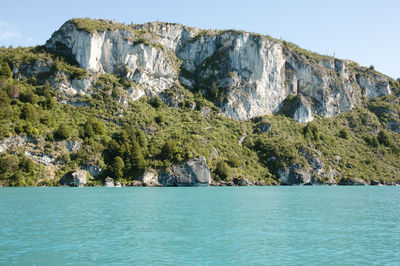 Scenic view of rocks in sea against sky