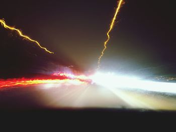 Close-up of light trails on road at night