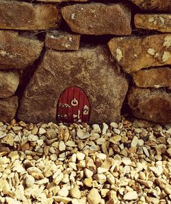 Pebbles on stone wall